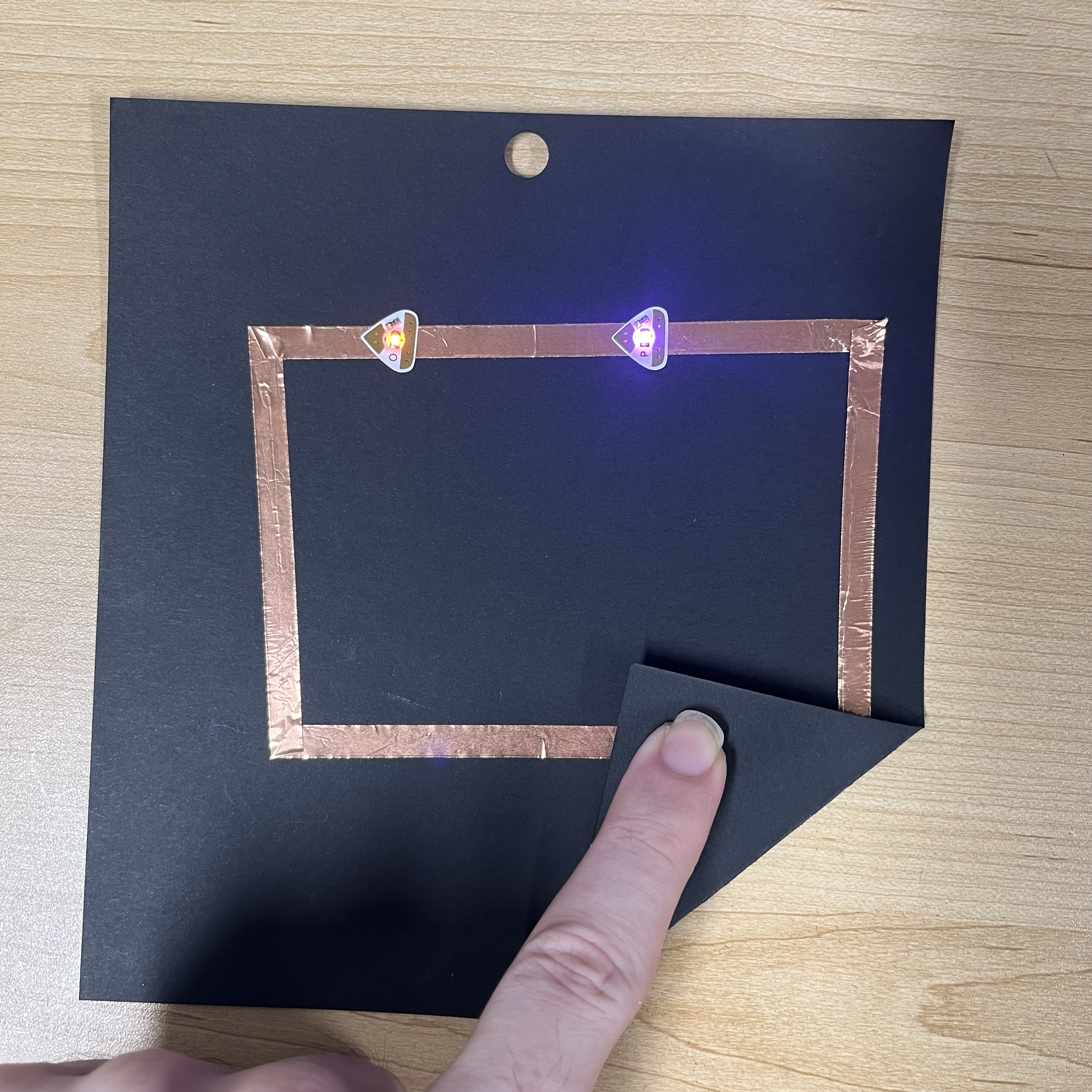 Here is the series circuit closed, with 2 batteries powering the 2 LED lights showing it is functional.