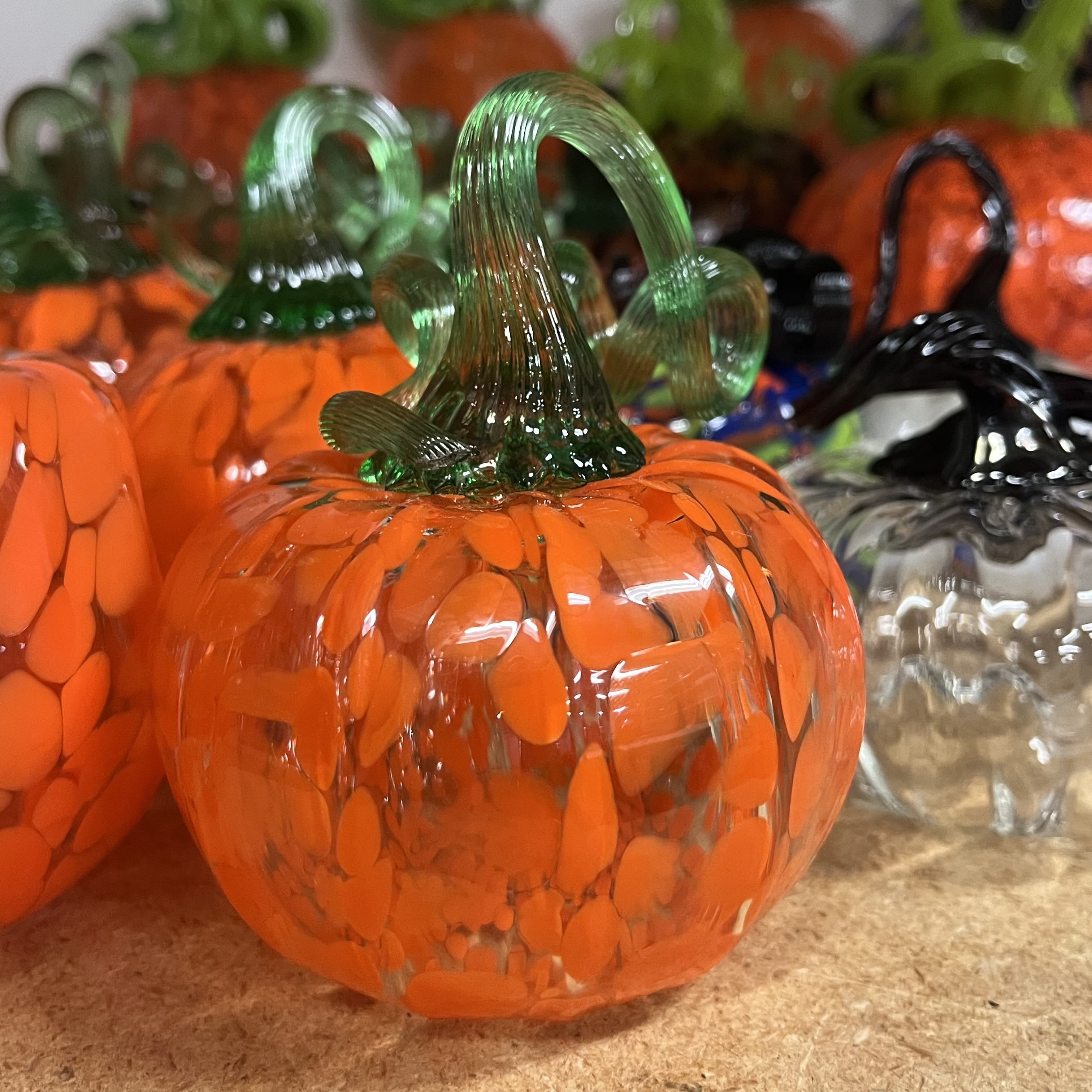Here is a series of pumpkins made for the craft and design glass sale, using soda lime (soft) glass. My friend in the glass program said the softer glass can't be mixed with harder (borosilicate) glass, as they have different thermal and expansion properties and will literally explode in the kiln if you try and fire them together. Soda lime glass is the most commonly made type of glass and is used extensively in many industries, from electronics to beverage containers, to decorative home goods and sculptural items like this pumpkin.